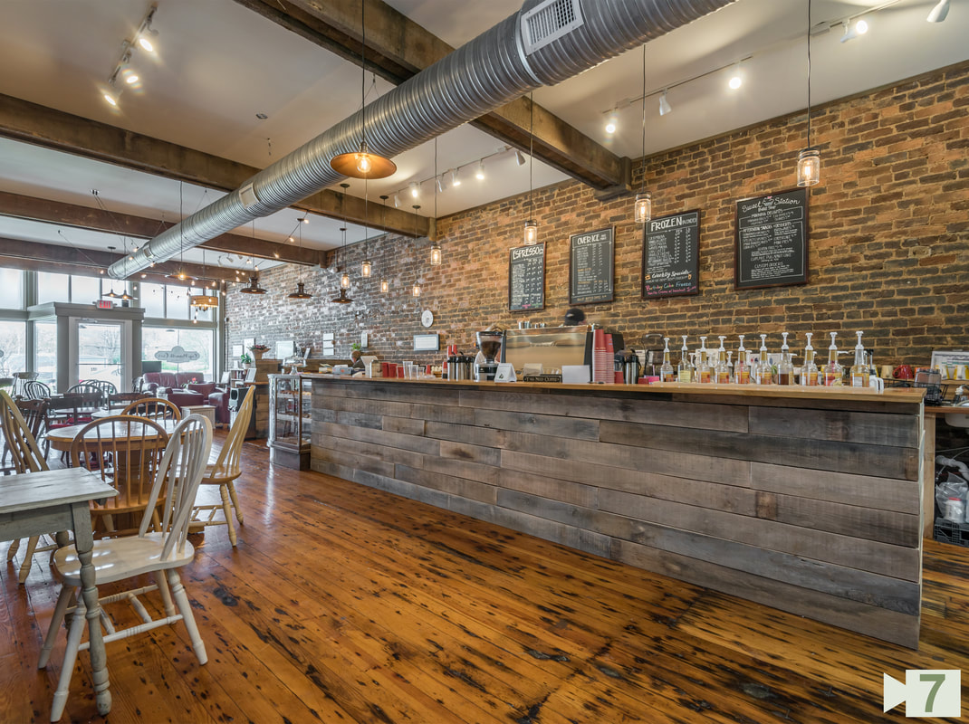 Finished Dining and Serving Areas with New floors, New ceilings, new beams, and Existing Brick Wall