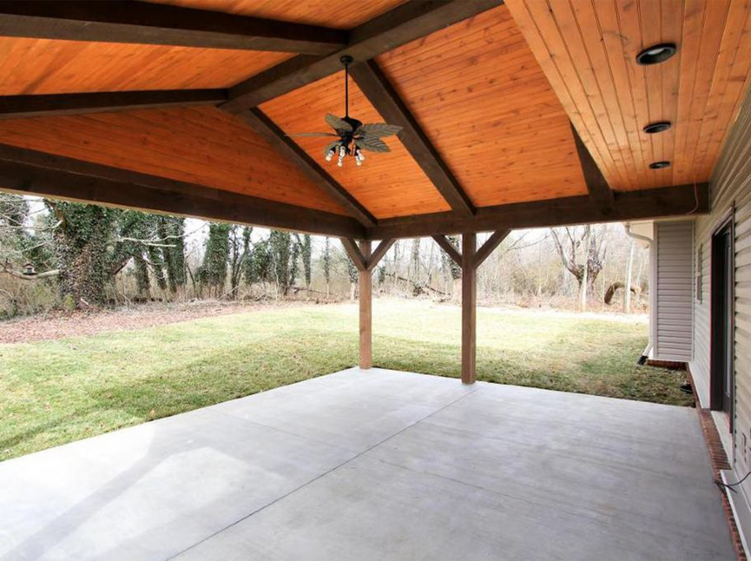 Concrete Back Pation Covered by Large Timber Posts and Beams with Tongue and Groove Wood Ceiling