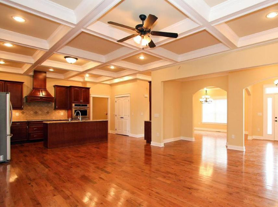 Living Area Connected to Kitchen with Hard Wood Flooring and Mahogany Cabinetry
