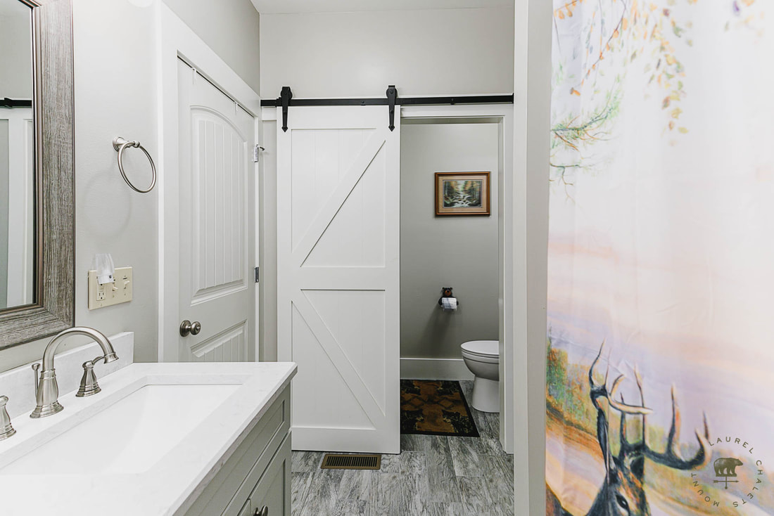Shared Deer Bathroom with Barn Door in the Gatlinburg Manor Chalet