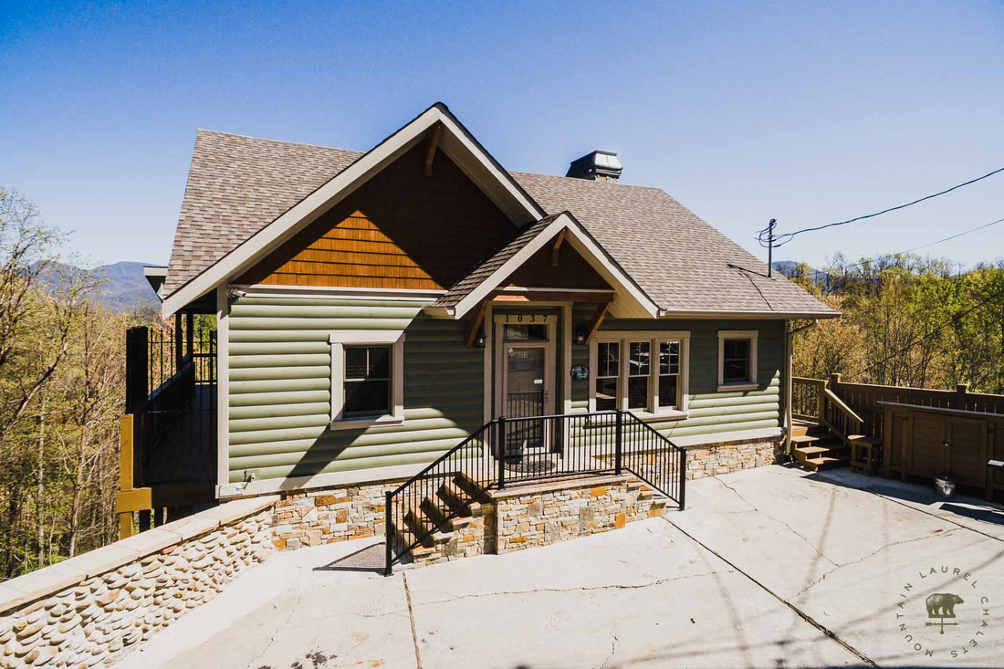 Exterior Shot of Gatlinburg Manor Chalet with Wrap-Around Porches, Stacked Stone, Log Look-a-Like, and Cedar Shake Siding