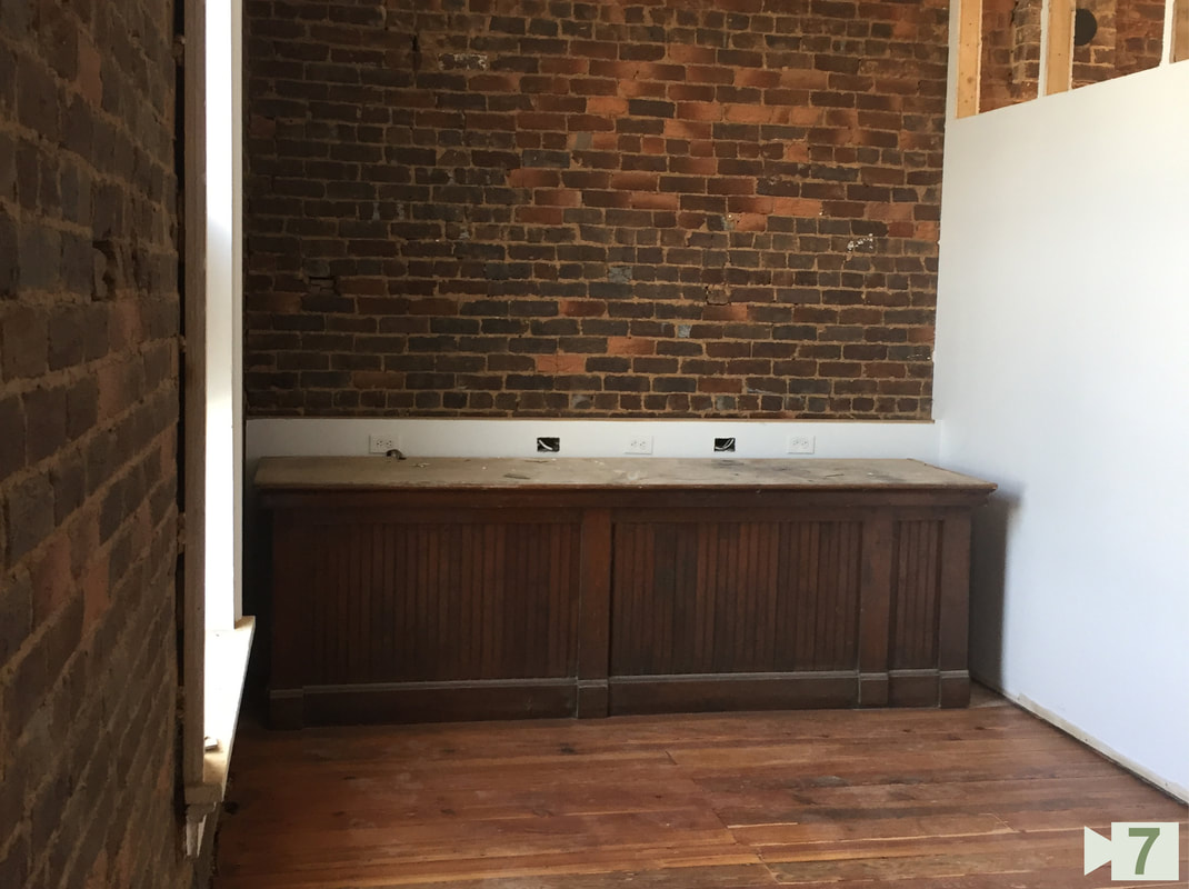 Conference Room with New Stained Floors and Drywall and Existing Brick Exterior Wall