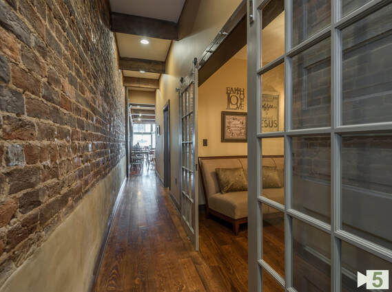 Finished Hallway with Existing Brick Walls and New Floors